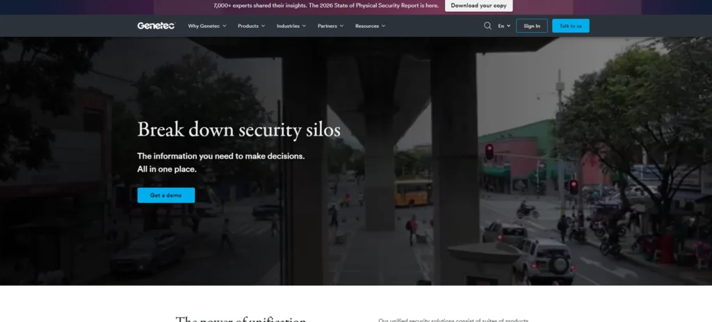 Screenshot of the Genetec homepage showing the headline “Break down security silos” with a city street background.