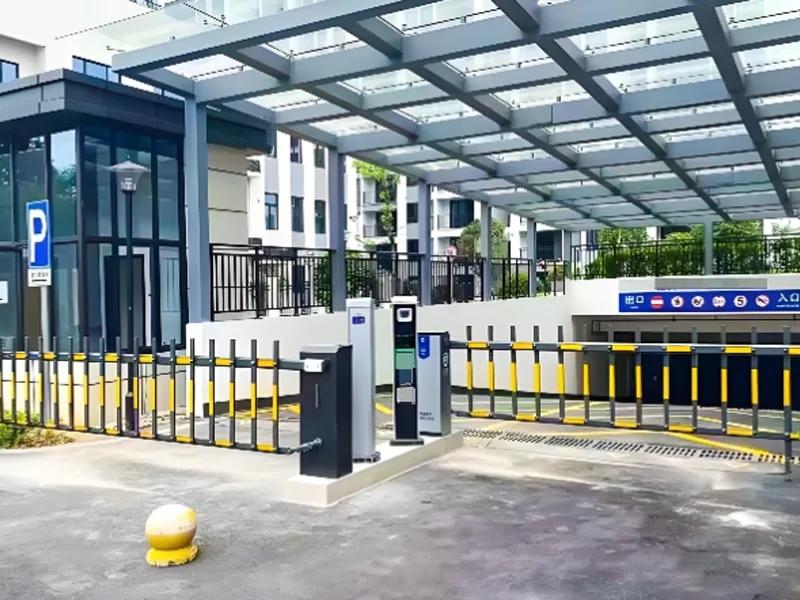 Modern parking entrance with barrier gates and automated access control equipment