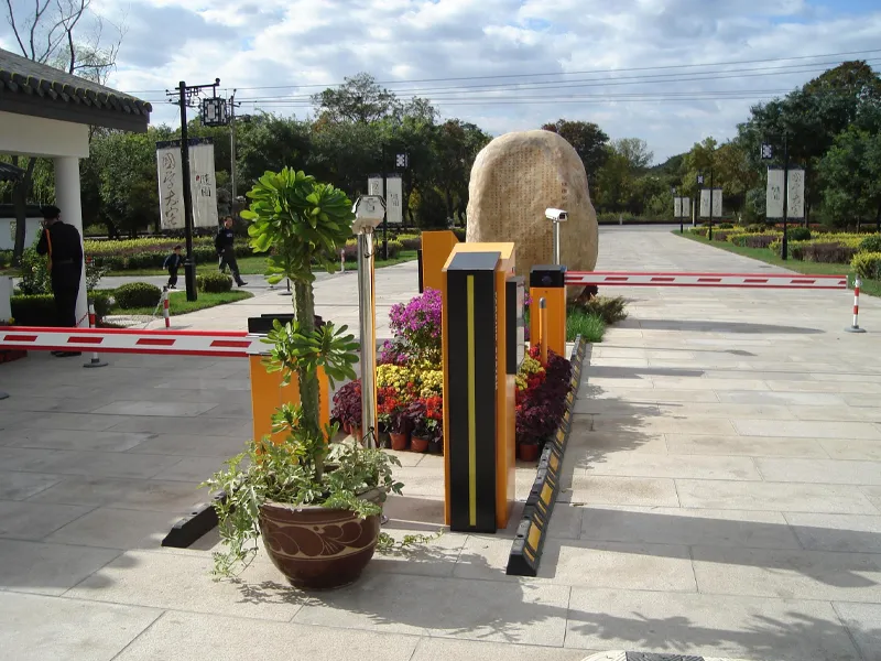 Automated vehicle access control system with barrier gate and camera at a gated entrance